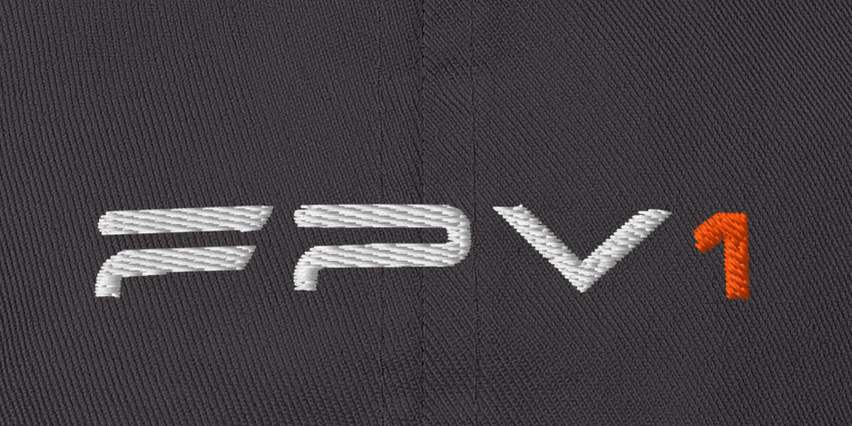 Dark grey FPV1 embroidered cap, close-up of the embroidered thin wordmark with orange 1